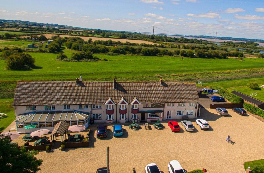 a-birds-eye-view-of-the-haven-inn-with-the-humber-bridge-in-the-background